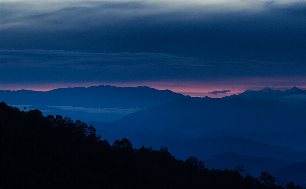Pink streak across the sky, under the clouds.