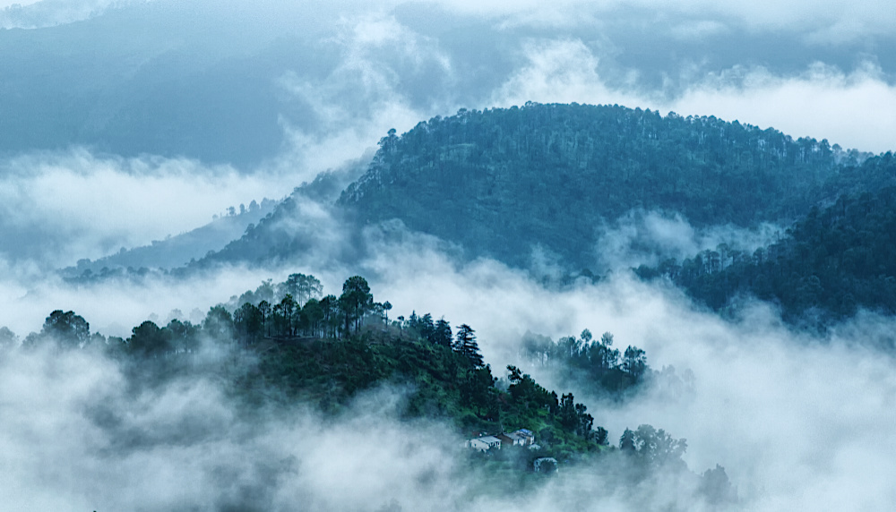 Clouds floating around the hills